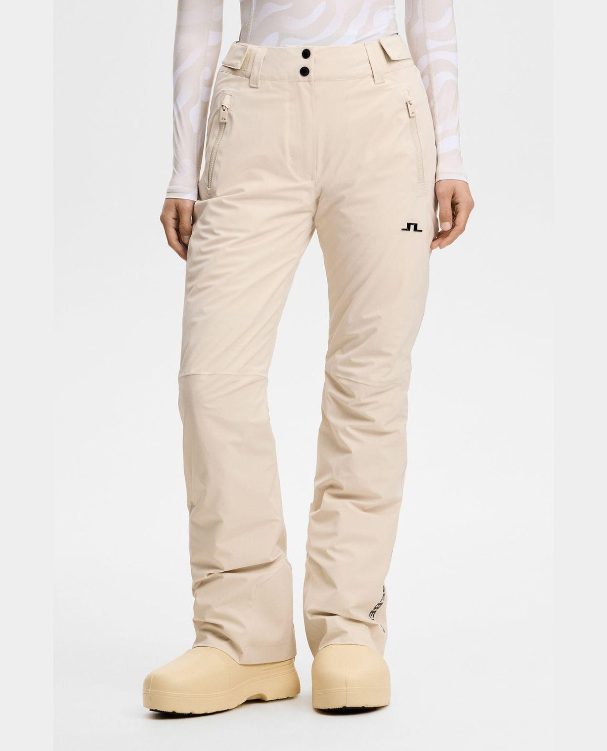 J.Lindeberg Elara Pant Women - Moonbeam beige skidbyxor för dam som visar framsidan av byxorna.