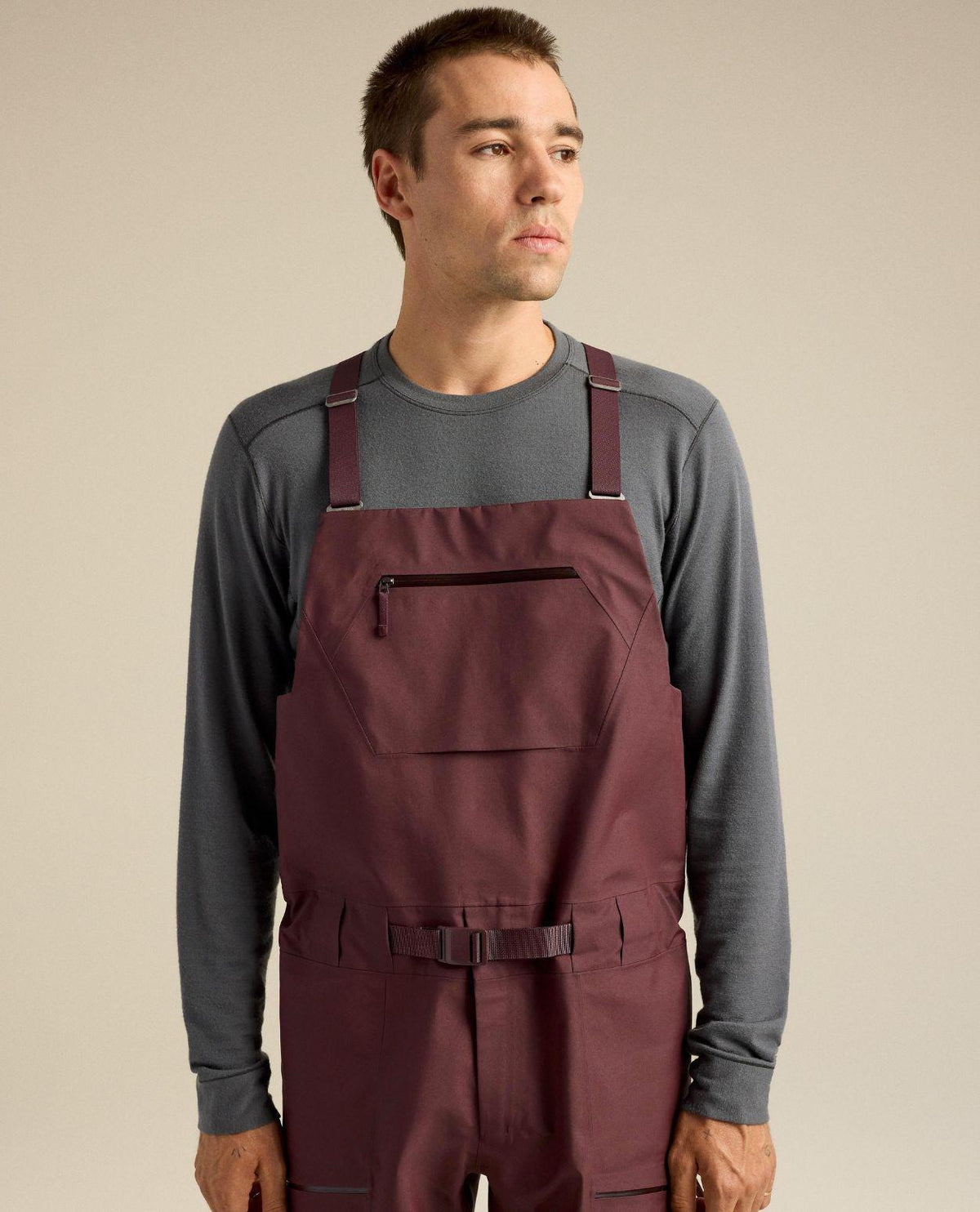 Man i lila hängselbyxor i modellen Arc'teryx Sabre Bib Men i färgen Ultima.