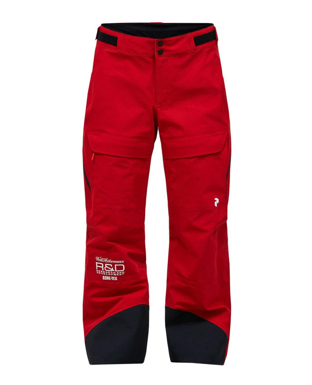 Peak Performance 40Y R&D Gore-Tex skidbyxor dam i rosa med tekniska detaljer.