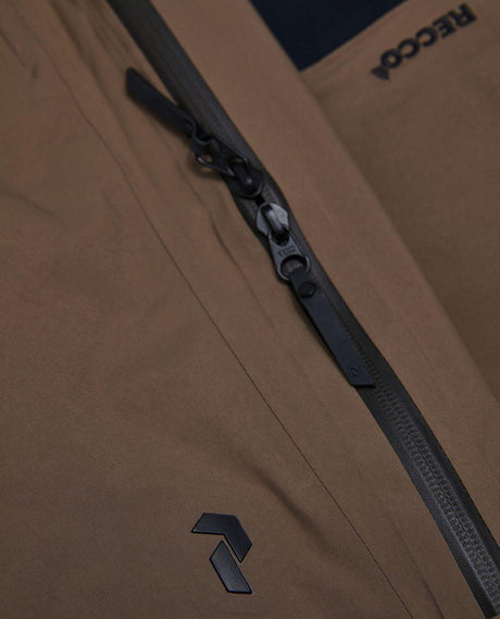 Detaljbild på vattentäta dragkedjor och Recco-reflektor på Peak Performance Alpine Gore-Tex Insulated Skidbyxor Dam Brun.