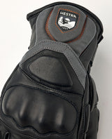 Hestra Impact Racing Sr 5 Finger knogskydd i svart läder med Hestra-logga.